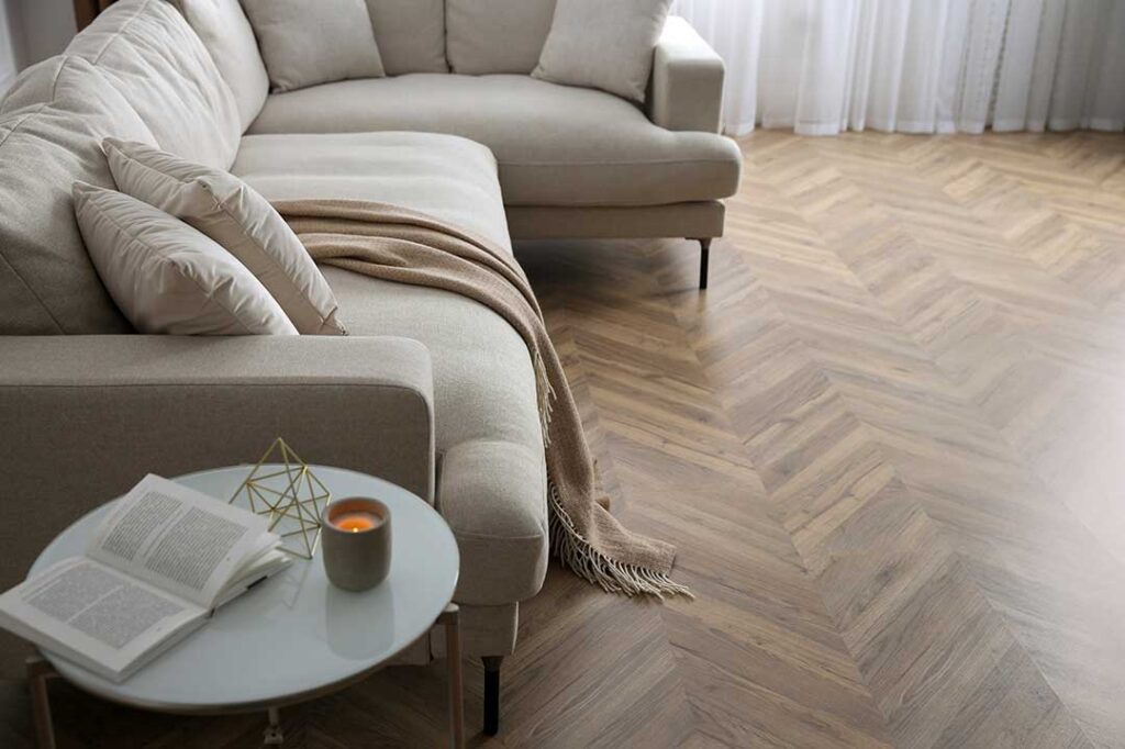 Person blotting a fresh pet stain on beige carpet with white towels and a spray cleaner